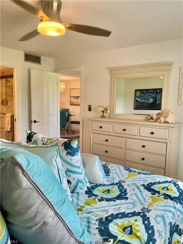 Bedroom featuring ensuite bathroom and ceiling fan