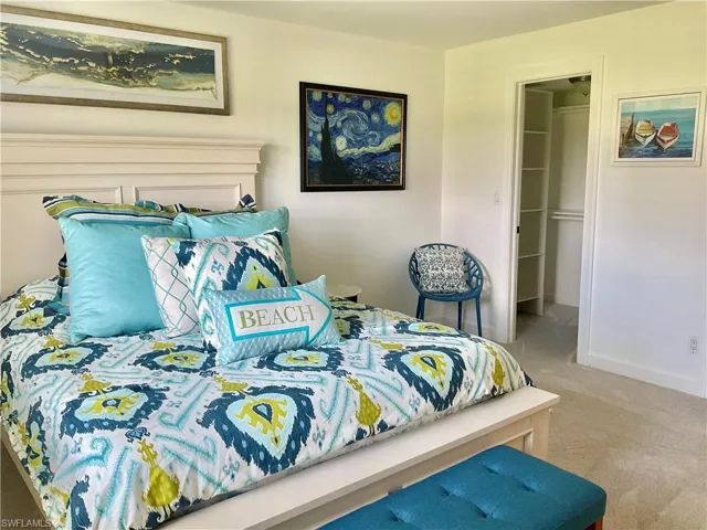 Carpeted bedroom with a closet and a spacious closet