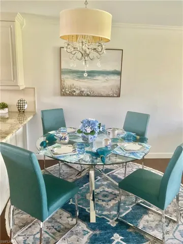 Dining room with an inviting chandelier and crown molding