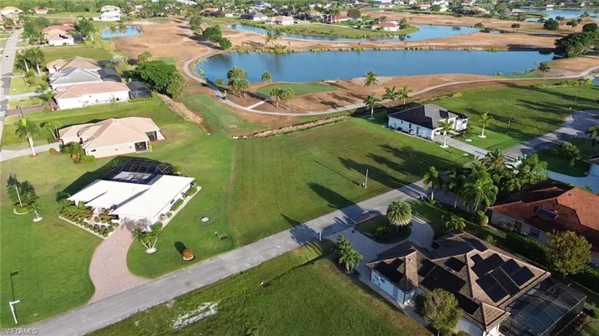 Aerial view of property's location featuring a large body of water and nearby suburban area