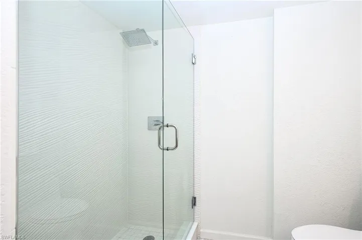 Remodeled Walk In Shower. take note of: wavy ceramic polished tile