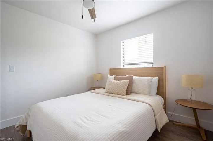 Bedroom featuring ceiling fan and dark hardwood / wood-style floors
