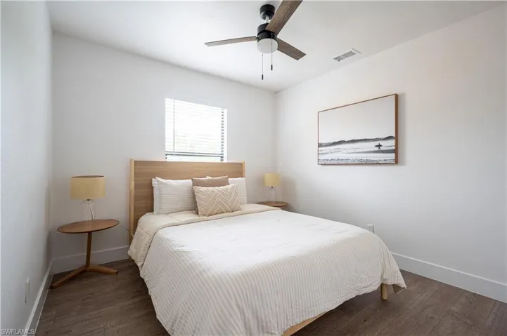 Bedroom featuring dark wood-type flooring and ceiling fan