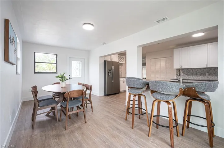 Dining space featuring light wood-type flooring and sink