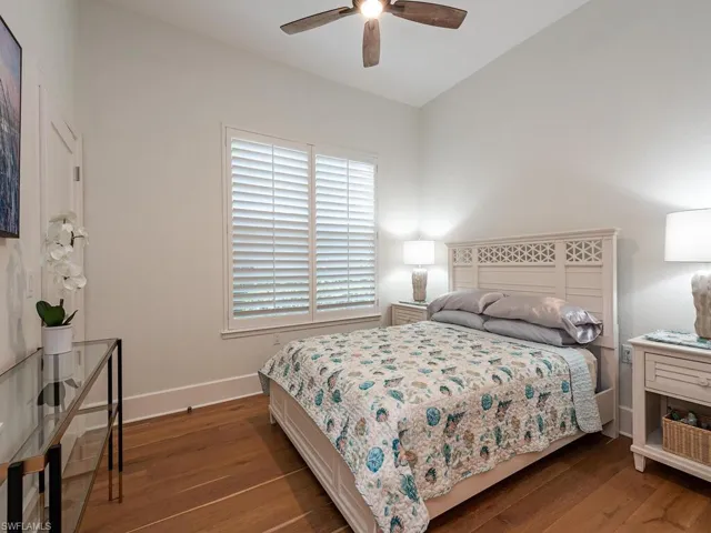 Bedroom featuring dark hardwood / wood-style floors and ceiling fan