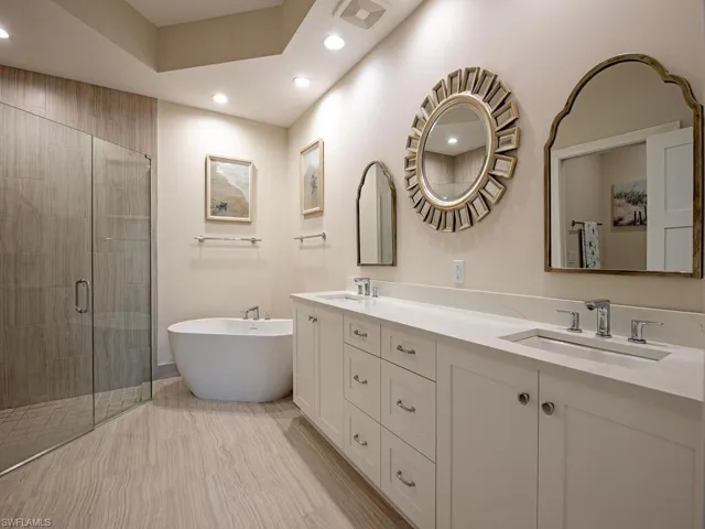 Bathroom featuring vanity and plus walk in shower