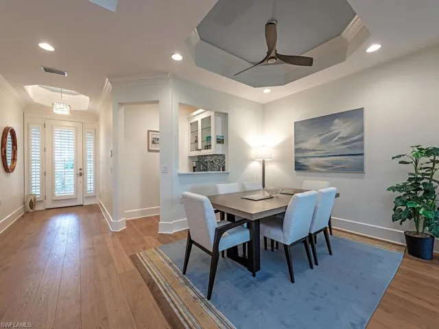 Dining room featuring a raised ceiling and ornamental molding