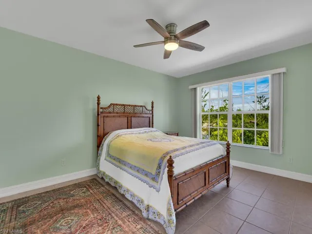 Tiled bedroom with ceiling fan