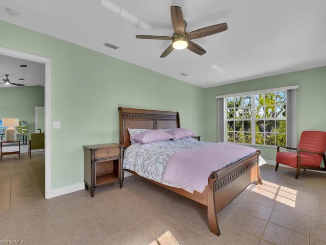 Bedroom featuring ceiling fan and light tile patterned flooring