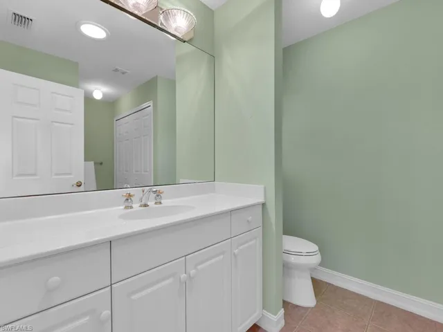 Bathroom featuring tile patterned floors, vanity, and toilet