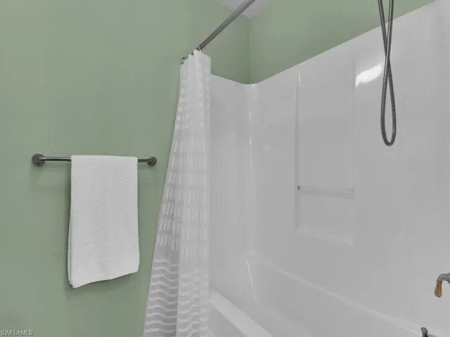 Bathroom featuring shower / bath combo with shower curtain