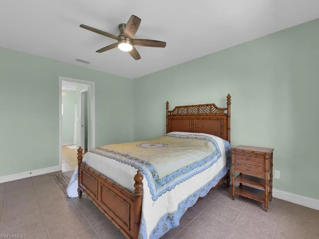 Tiled bedroom with ceiling fan