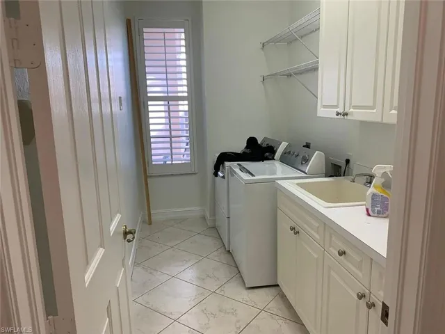 Laundry room with cabinet space and independent washer and dryer