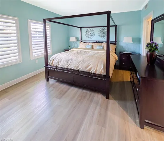 Bedroom with light wood-style floors and baseboards