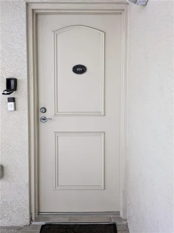 View of exterior entry featuring stucco siding