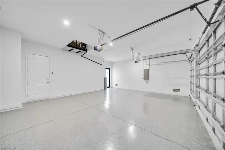 Garage with a garage door opener and electric panel