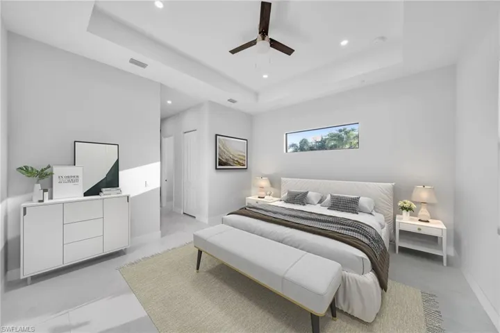 Bedroom featuring a tray ceiling and ceiling fan