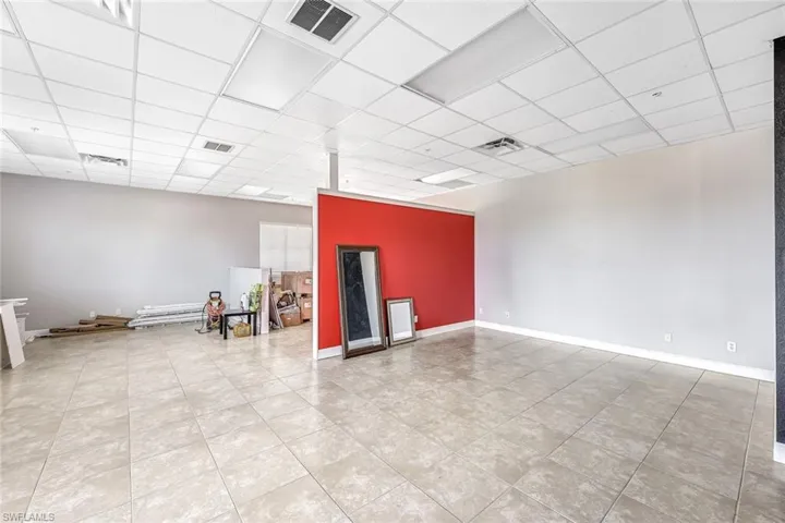 ESuite 2 empty room with light tile patterned floors and a paneled ceiling