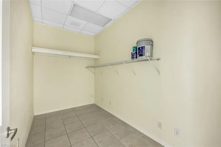 Suite 1 Walk in closet featuring a drop ceiling and light tile patterned floors