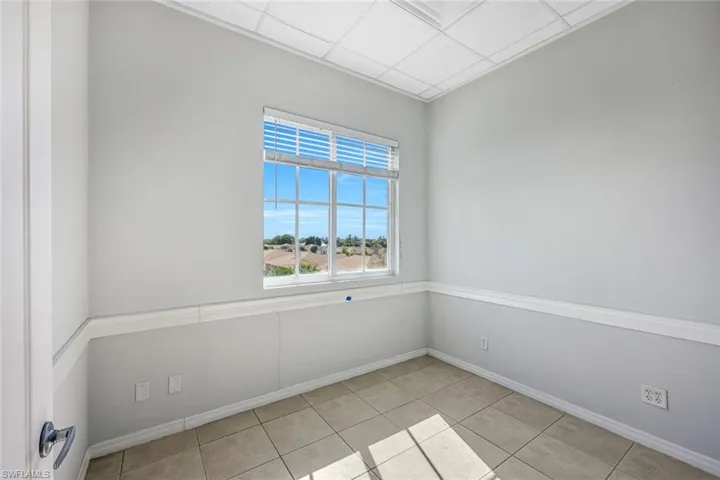 Suite 1 paneled ceiling and light tile patterned floors