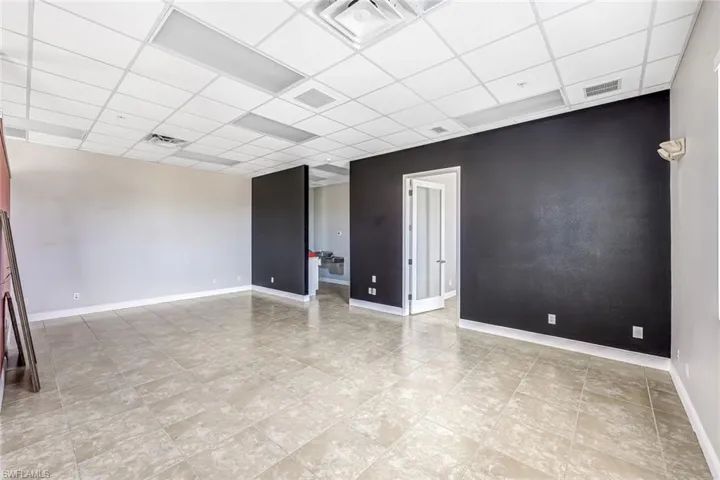 Suite 2 Empty room featuring baseboards and a drop ceiling