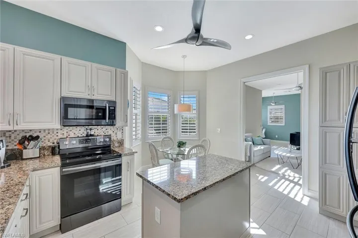 large pantry with pullouts to the right of the photo affords PLENTY of space!  Kitchen opens to den and living areas.