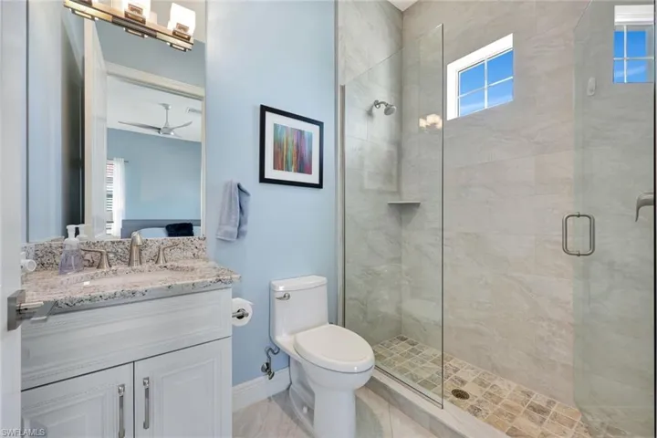 Ensuite guest bathroom featuring oversized frameless shower