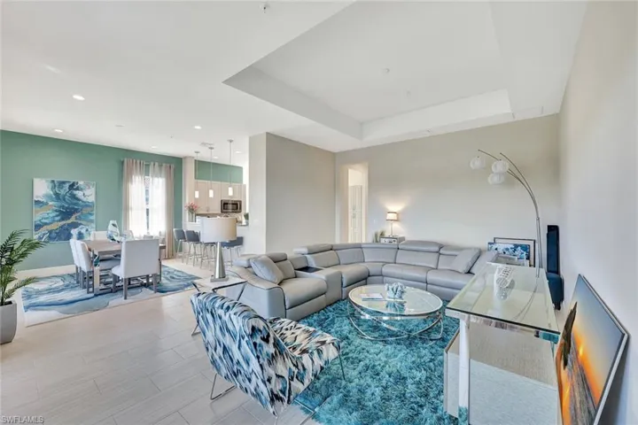 Open bright living/dining area boasting gorgeous light wood plank TILE (throughout the home)