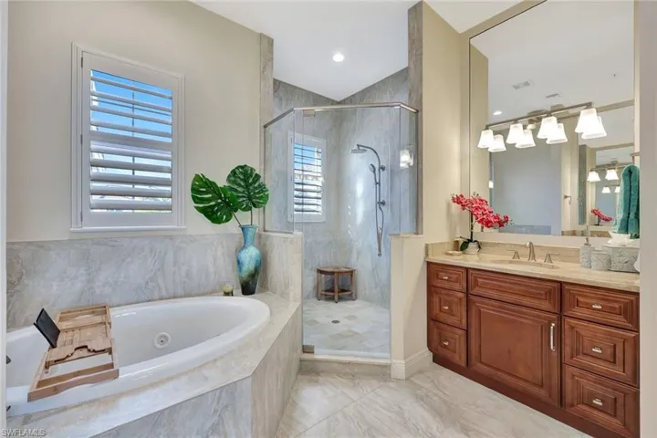 Huge walk-in shower, jetted tub, and double vanities welcome you to the primary bathroom