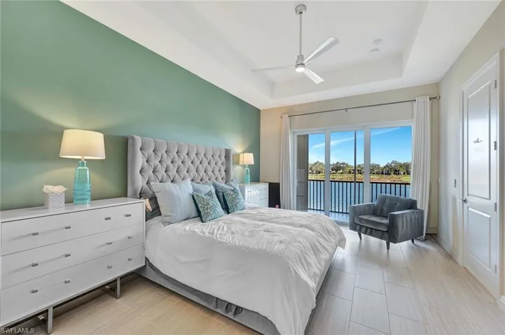 Luxurious primary suite with sliders to the lanai and THOSE views