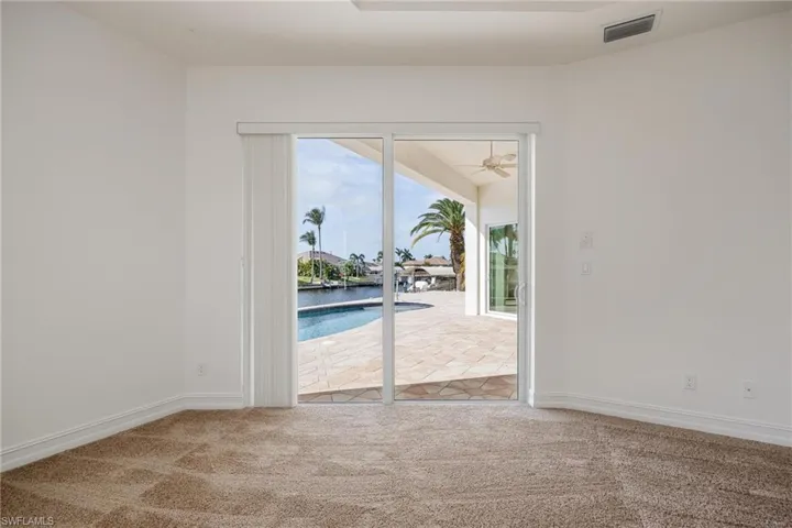 Carpeted spare room featuring ceiling fan