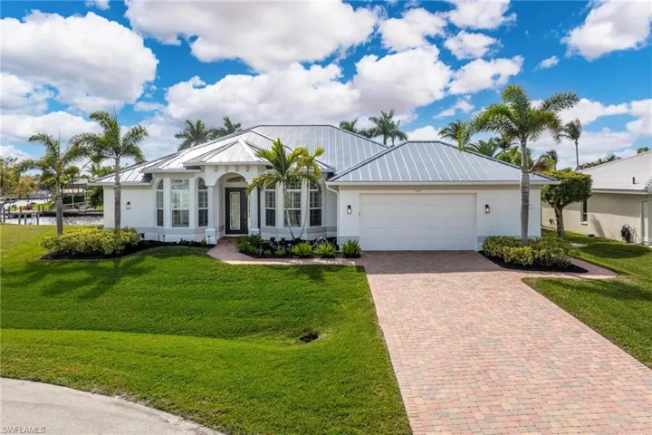 Single story home with a front yard and a garage
