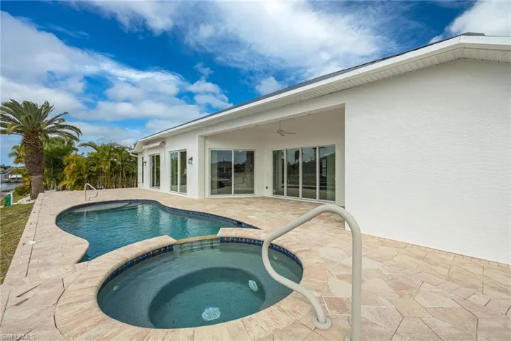 View of pool with an in ground hot tub, a patio, and ceiling fan