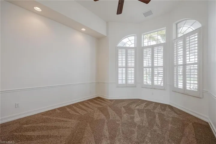 Unfurnished room featuring ceiling fan and carpet floors