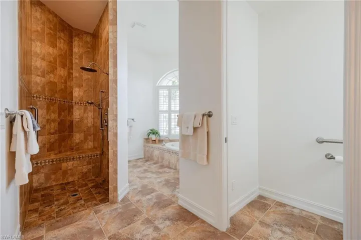 Bathroom featuring tile patterned floors and separate shower and tub