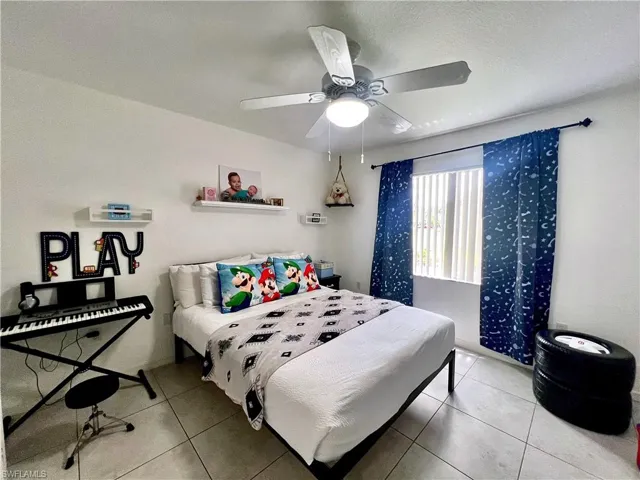 Bedroom with tile flooring and ceiling fan