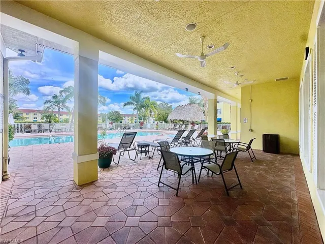 View of patio / terrace featuring a community pool and ceiling fan