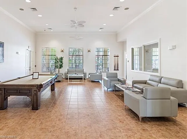 Game room with ornamental molding, light tile flooring, ceiling fan, and pool table