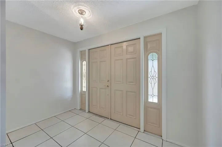 Tiled entryway with a  wealth of natural light