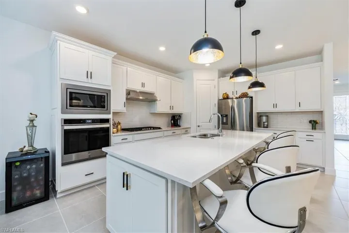 gas cooking and quartz countertops and stainless appliances and huge island