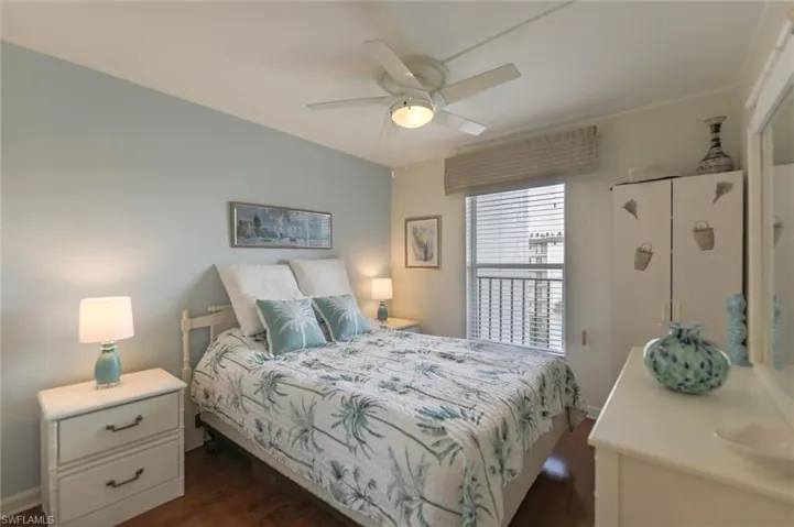 Bedroom with dark hardwood / wood-style floors and ceiling fan