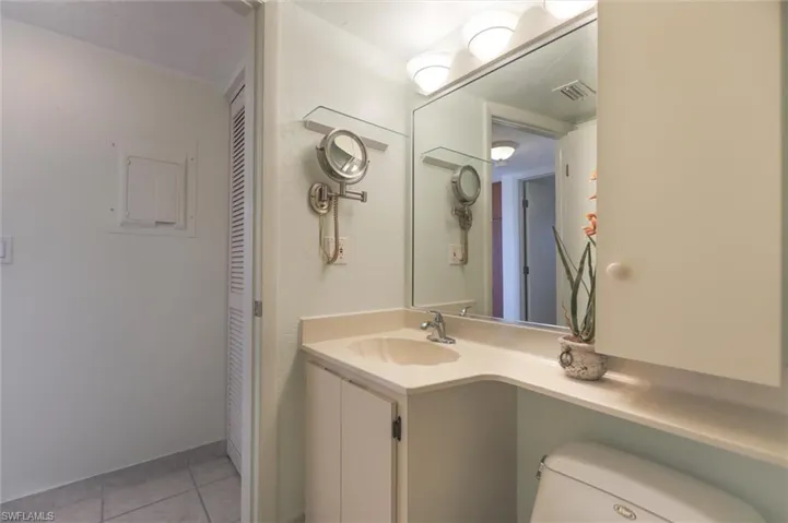 Bathroom featuring vanity, toilet, and tile floors