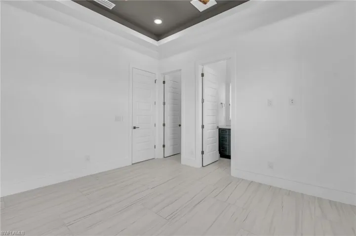Unfurnished room with a raised ceiling
