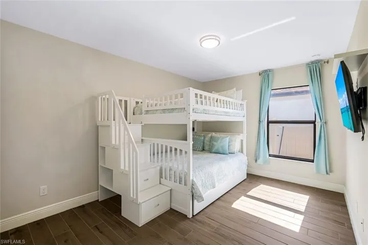 Unfurnished bedroom featuring hardwood / wood-style floors