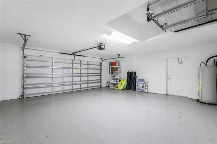 Garage with water heater and a garage door opener