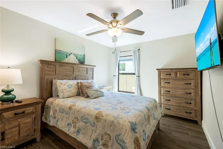 Bedroom featuring dark hardwood / wood-style floors and ceiling fan