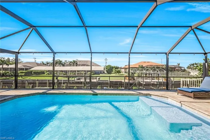 View of swimming pool featuring a patio and a lanai