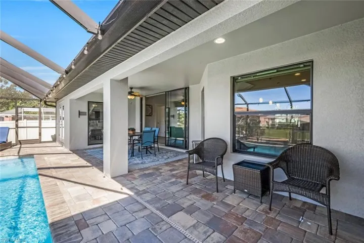 View of patio / terrace with ceiling fan, a fenced in pool, and glass enclosure
