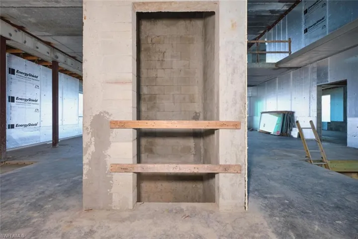 Staircase with unfinished concrete flooring