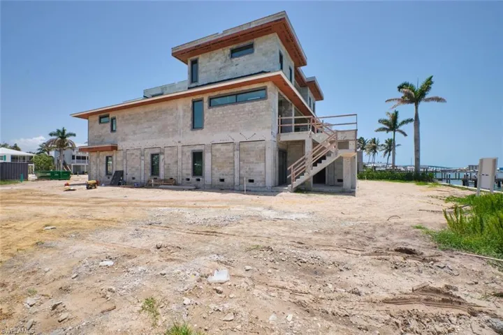 Back of property with stairway and a deck